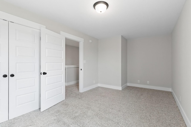 unfurnished bedroom featuring light colored carpet