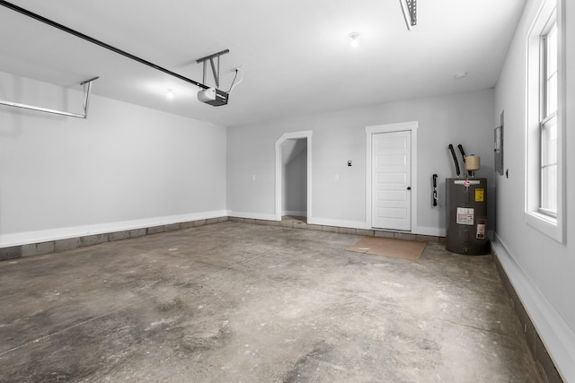 garage with a garage door opener and water heater