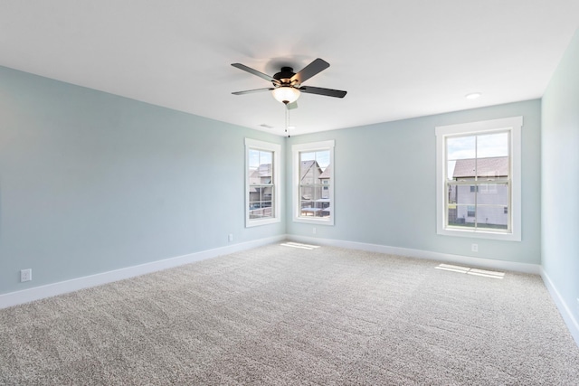 carpeted spare room with ceiling fan