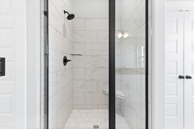 bathroom featuring a shower with door