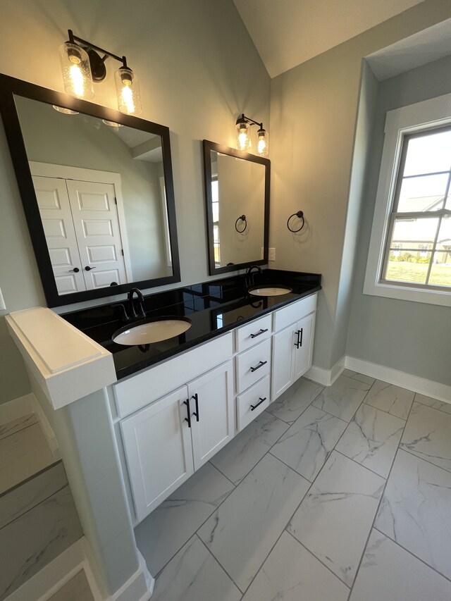 bathroom with lofted ceiling and vanity