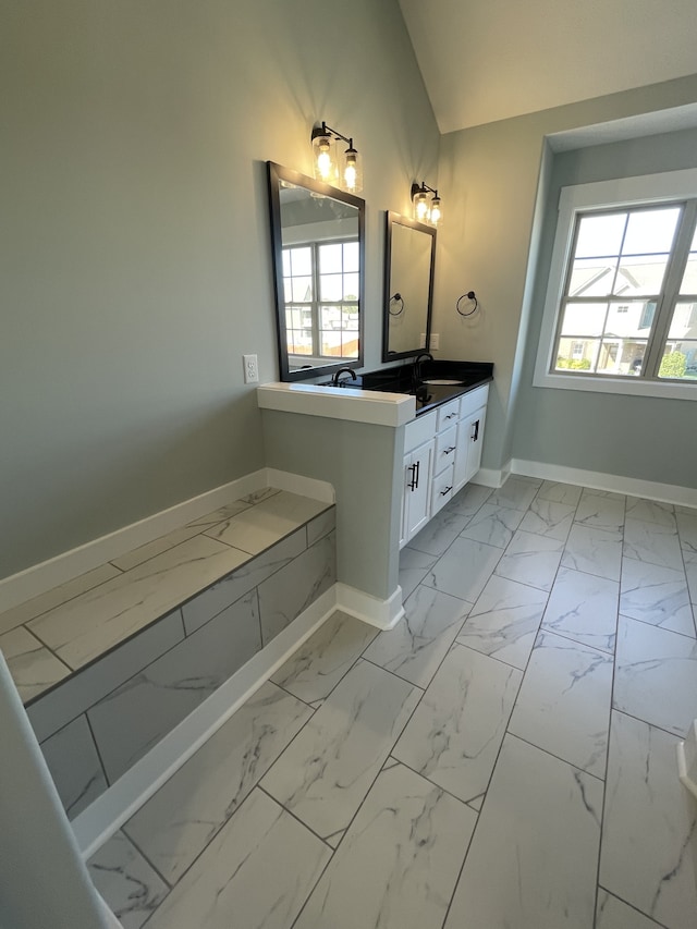 bathroom featuring vanity and vaulted ceiling