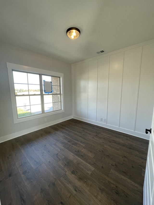 spare room featuring dark hardwood / wood-style flooring