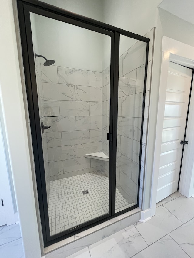 bathroom with a shower with shower door