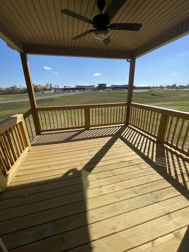 wooden deck with a rural view and ceiling fan