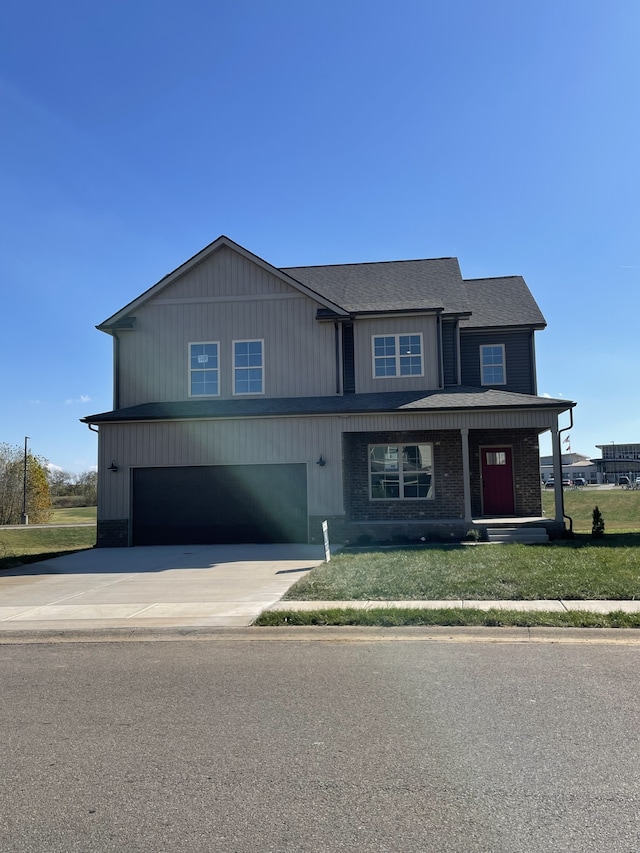 view of front of property featuring a front lawn and a garage