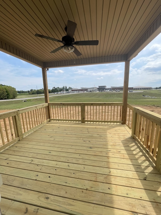 wooden deck featuring ceiling fan and a rural view