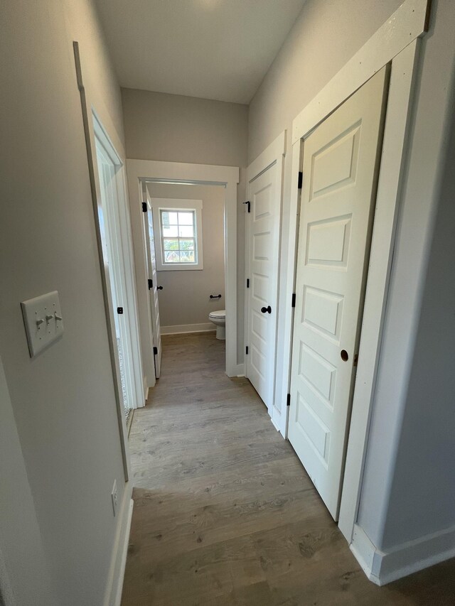 corridor with light hardwood / wood-style flooring