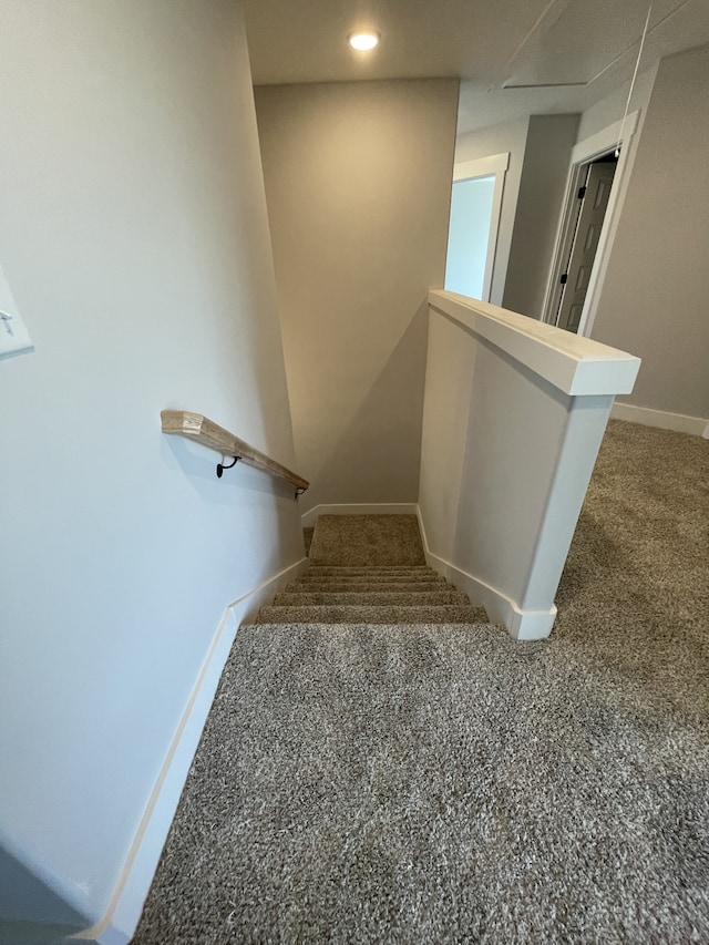 stairs featuring carpet