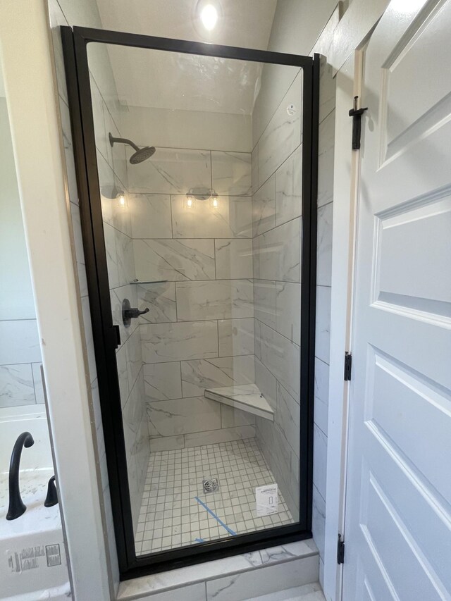 bathroom featuring a shower with door