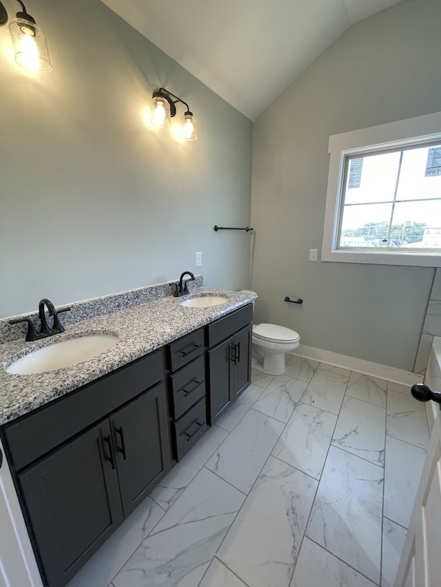 bathroom featuring vaulted ceiling, vanity, and toilet