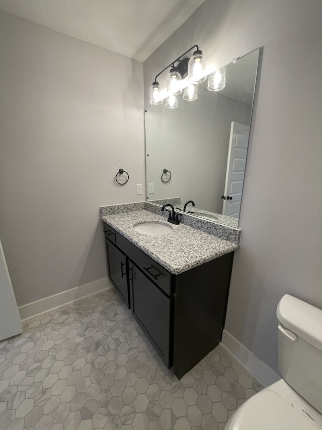 bathroom featuring vanity, tile patterned floors, and toilet