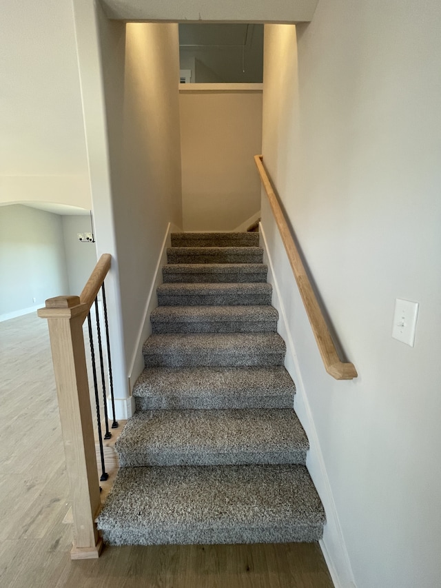 stairs with hardwood / wood-style flooring