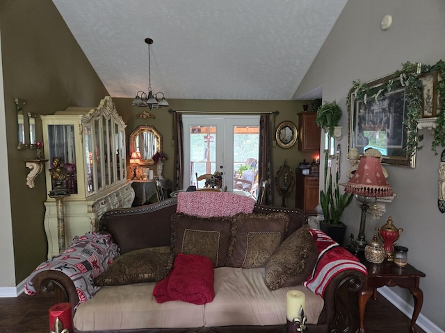 living room with french doors, a chandelier, vaulted ceiling, and a textured ceiling