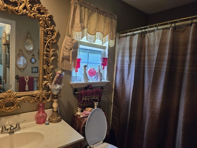 bathroom featuring sink and curtained shower