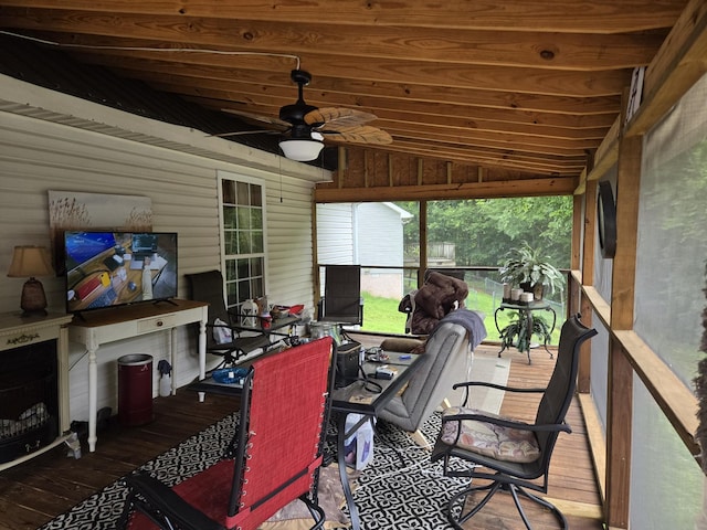 sunroom / solarium with ceiling fan and lofted ceiling