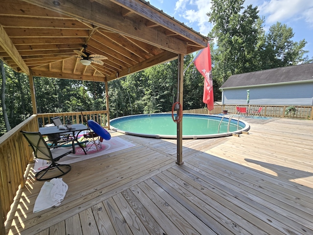 view of pool featuring a deck and ceiling fan