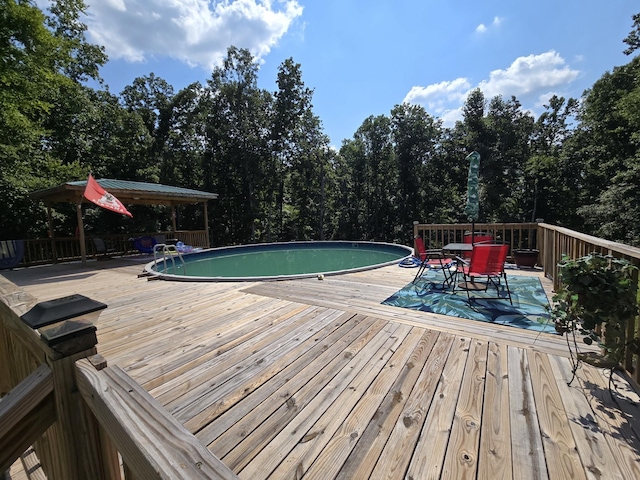 pool with a deck and outdoor dining space