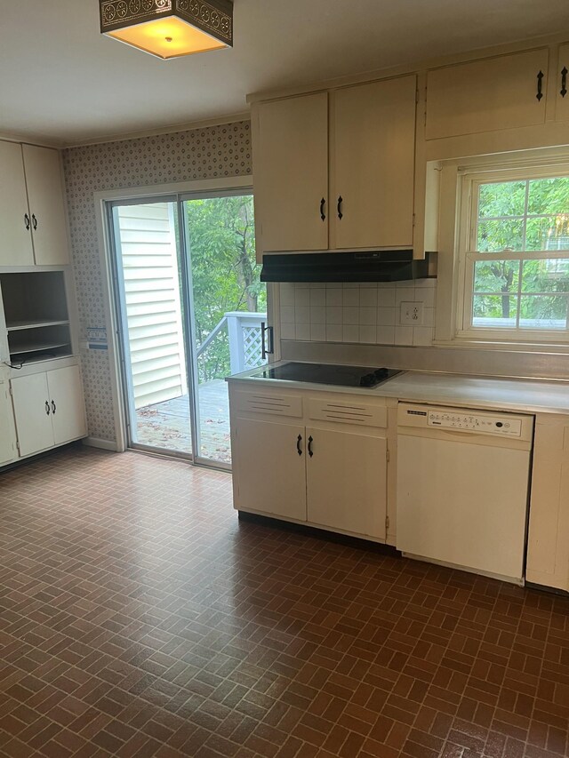 kitchen featuring dishwasher, white cabinetry, cooktop, and decorative backsplash