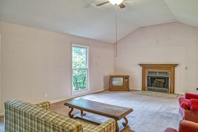 living room with carpet, vaulted ceiling, a textured ceiling, and ceiling fan