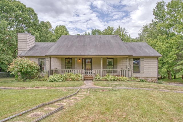 ranch-style house with a front yard and covered porch