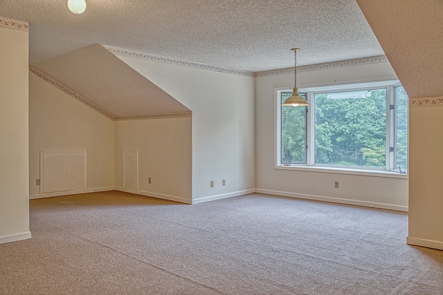 bonus room featuring a textured ceiling, light colored carpet, and vaulted ceiling