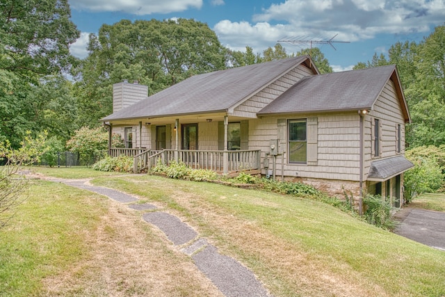 single story home featuring covered porch and a front lawn