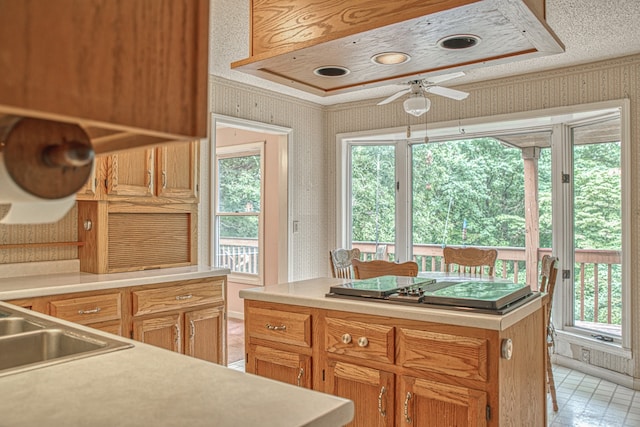 kitchen with a center island, light tile patterned floors, and ceiling fan