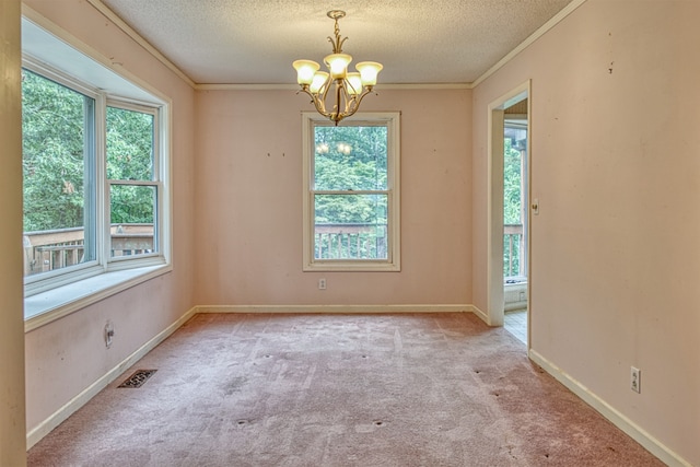 unfurnished room featuring a wealth of natural light, light carpet, and a textured ceiling