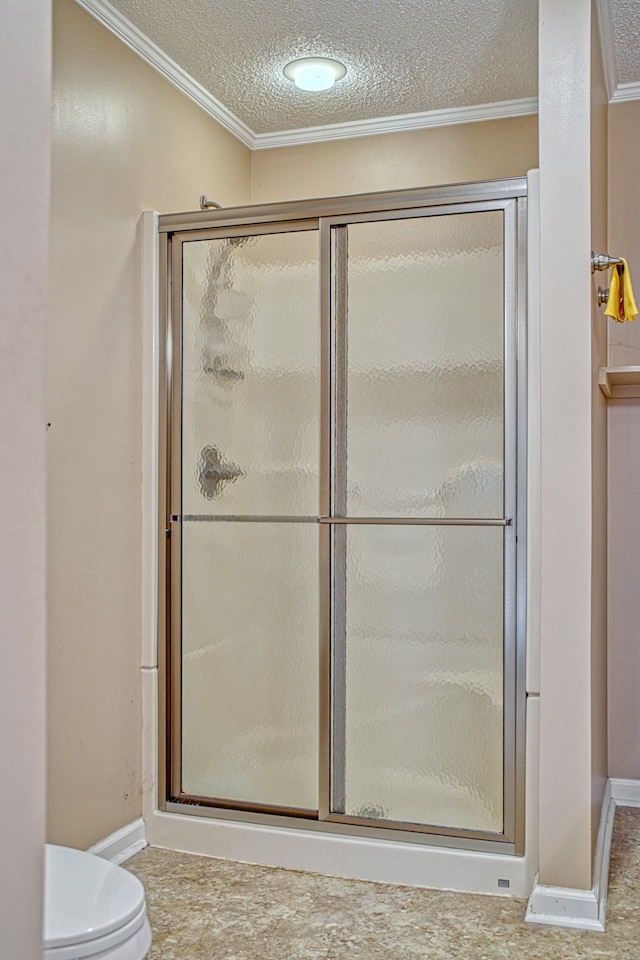 bathroom with toilet, walk in shower, a textured ceiling, and ornamental molding