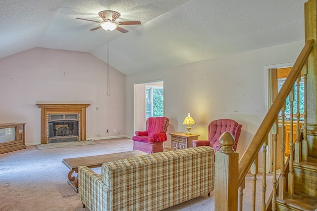 carpeted living room featuring vaulted ceiling, a textured ceiling, and ceiling fan