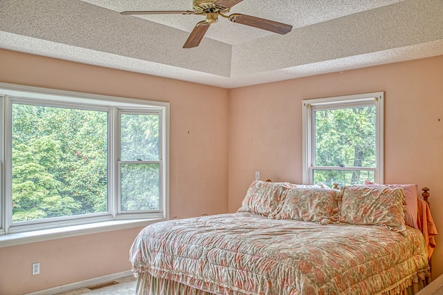 bedroom featuring ceiling fan and a textured ceiling