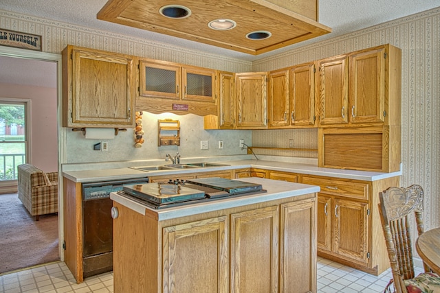 kitchen featuring sink, dishwasher, a center island, and a textured ceiling