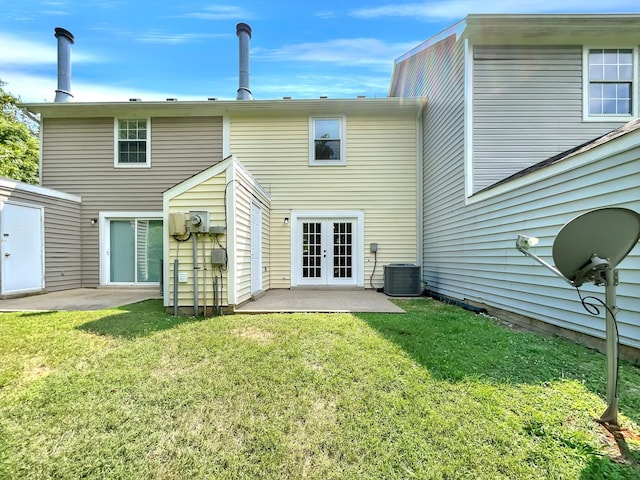 rear view of house featuring a patio, central AC, french doors, and a lawn