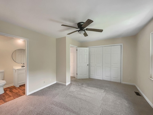 unfurnished bedroom with connected bathroom, a closet, ceiling fan, and carpet