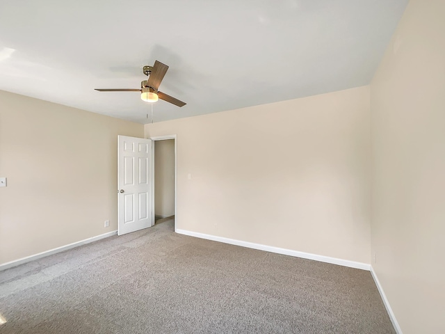 carpeted spare room with ceiling fan