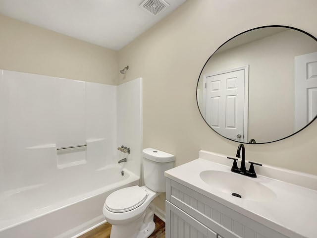 full bathroom featuring vanity, hardwood / wood-style flooring,  shower combination, and toilet