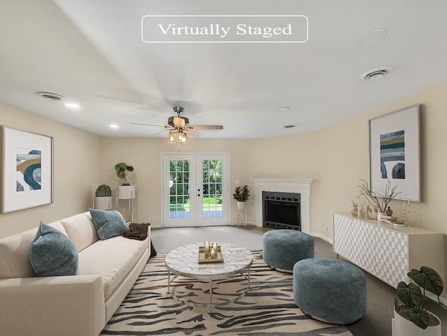 carpeted living room with ceiling fan and french doors