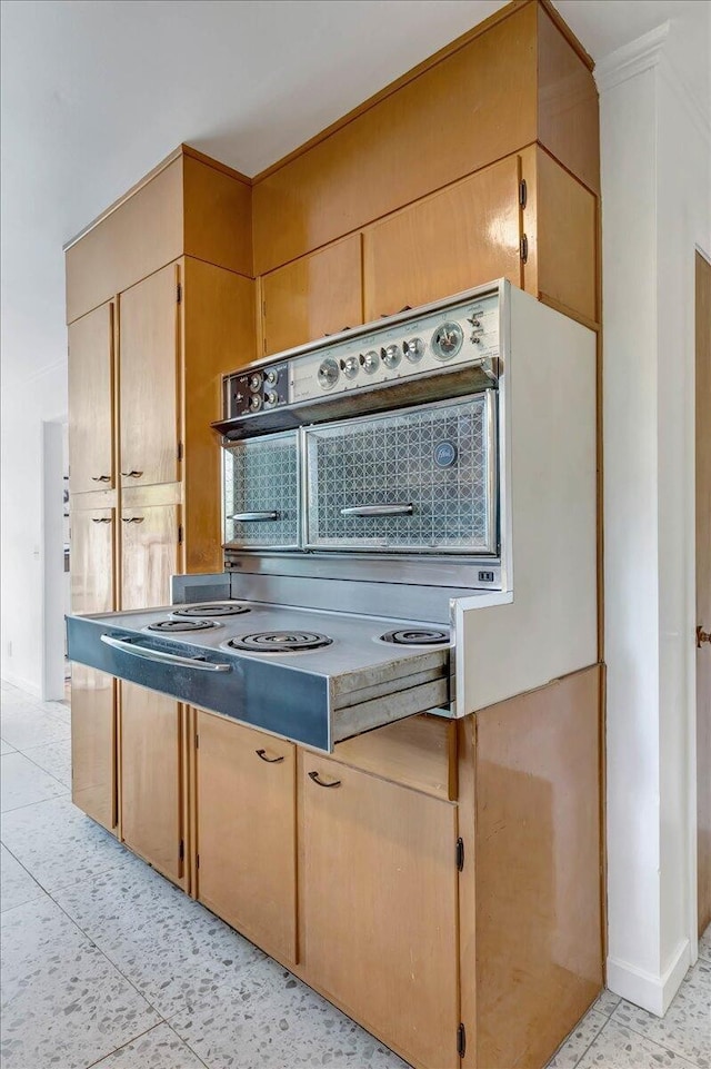 kitchen featuring light tile patterned flooring and light brown cabinets