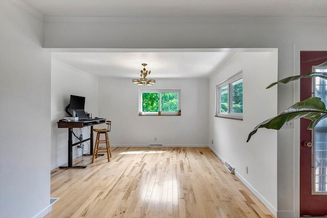 office area featuring a chandelier, ornamental molding, and light hardwood / wood-style floors