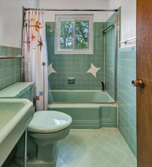 full bathroom featuring tile patterned flooring, tile walls, shower / bath combo, and toilet