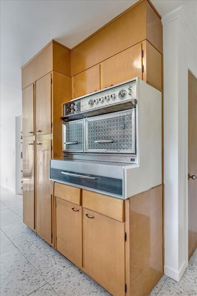 kitchen featuring light brown cabinetry and light tile patterned floors