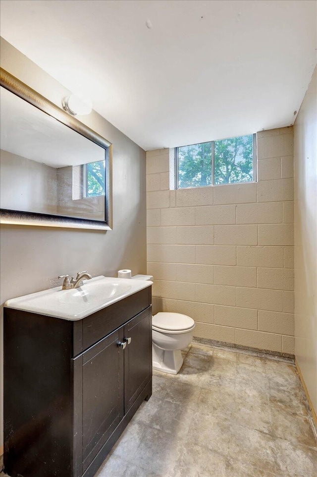 bathroom with vanity, tile patterned flooring, toilet, and a wealth of natural light