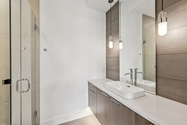 bathroom featuring vanity and a shower with shower door