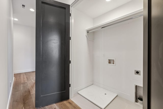 laundry area with hardwood / wood-style flooring, washer hookup, and hookup for an electric dryer