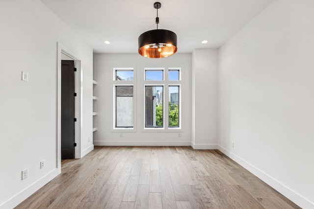 unfurnished room with light hardwood / wood-style floors