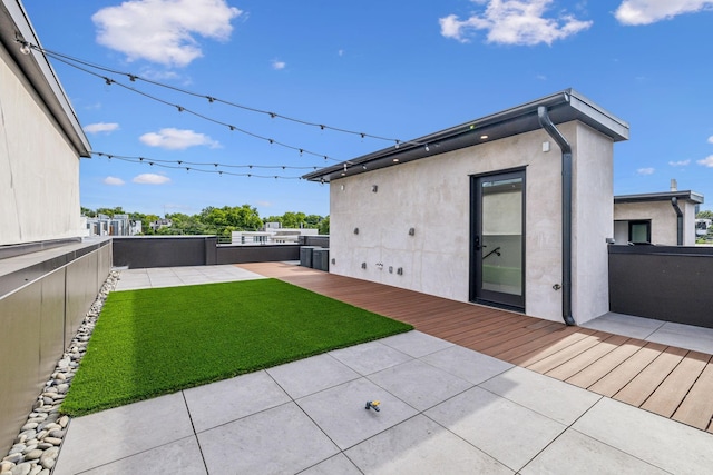 exterior space featuring a patio area and a lawn