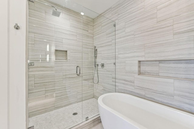 bathroom with shower with separate bathtub