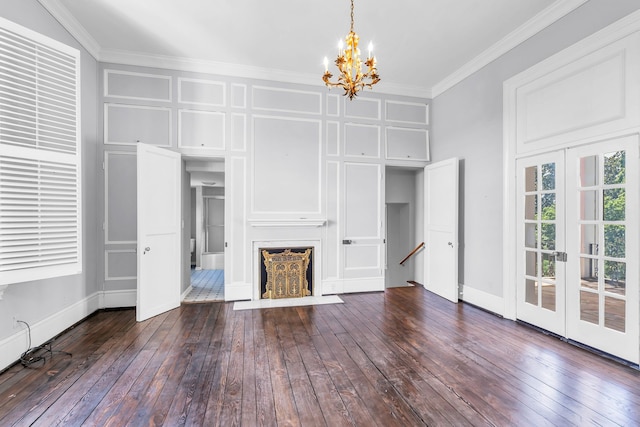 unfurnished living room with wood-type flooring, crown molding, a chandelier, and french doors