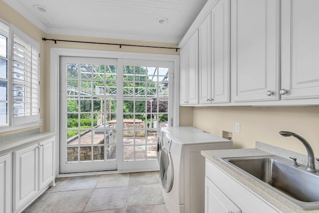 clothes washing area with light tile patterned floors, independent washer and dryer, sink, and cabinets